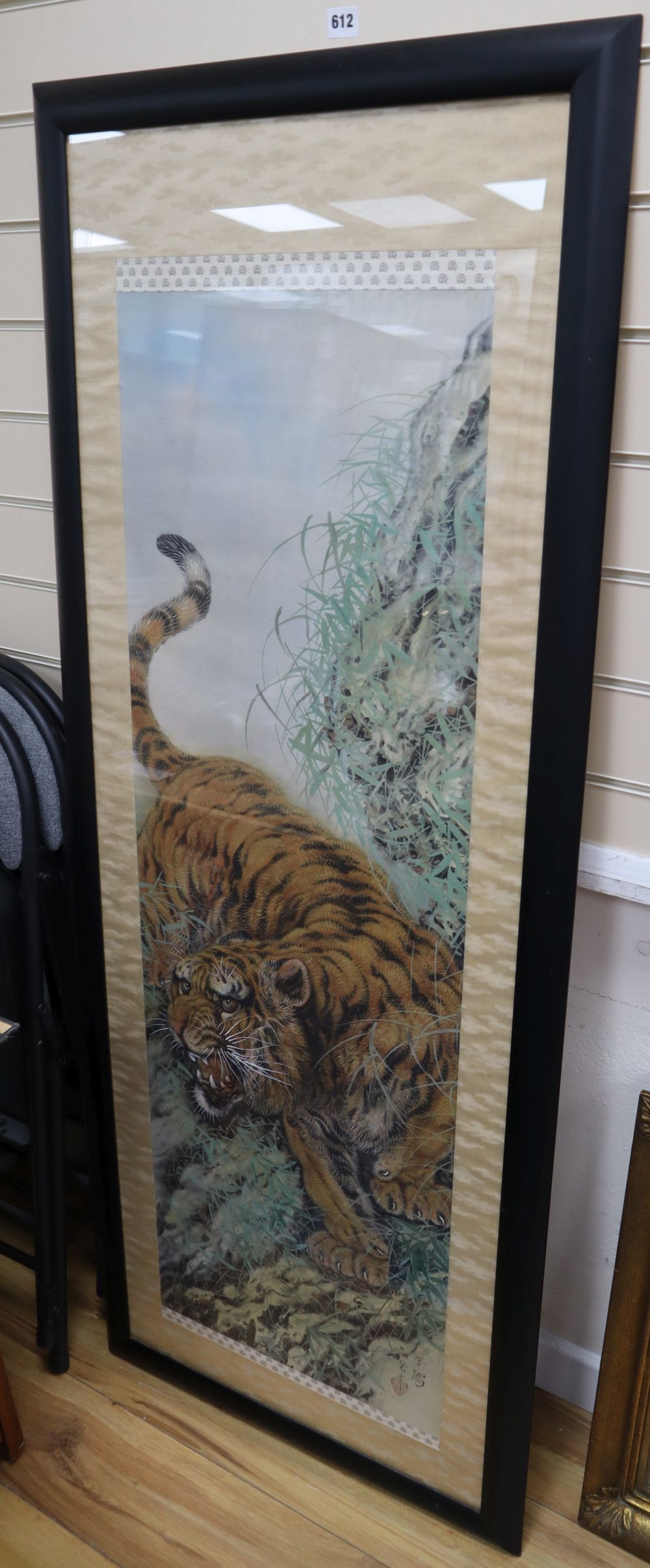 Chinese School (20th century), study of a tiger in a mountainous landscape, watercolour on silk, 125cm x 41cm approx